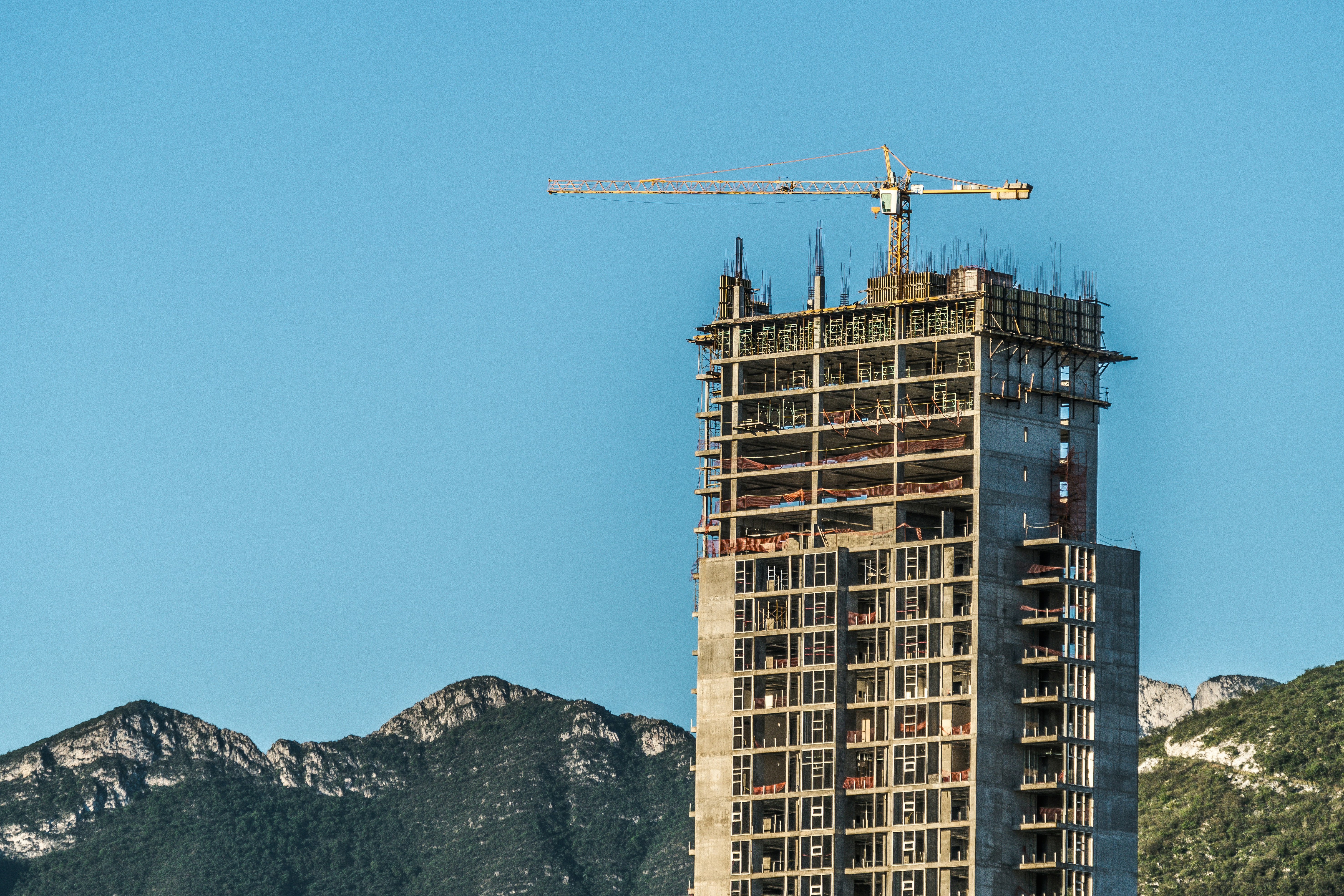 brown concrete building near mountain during daytime